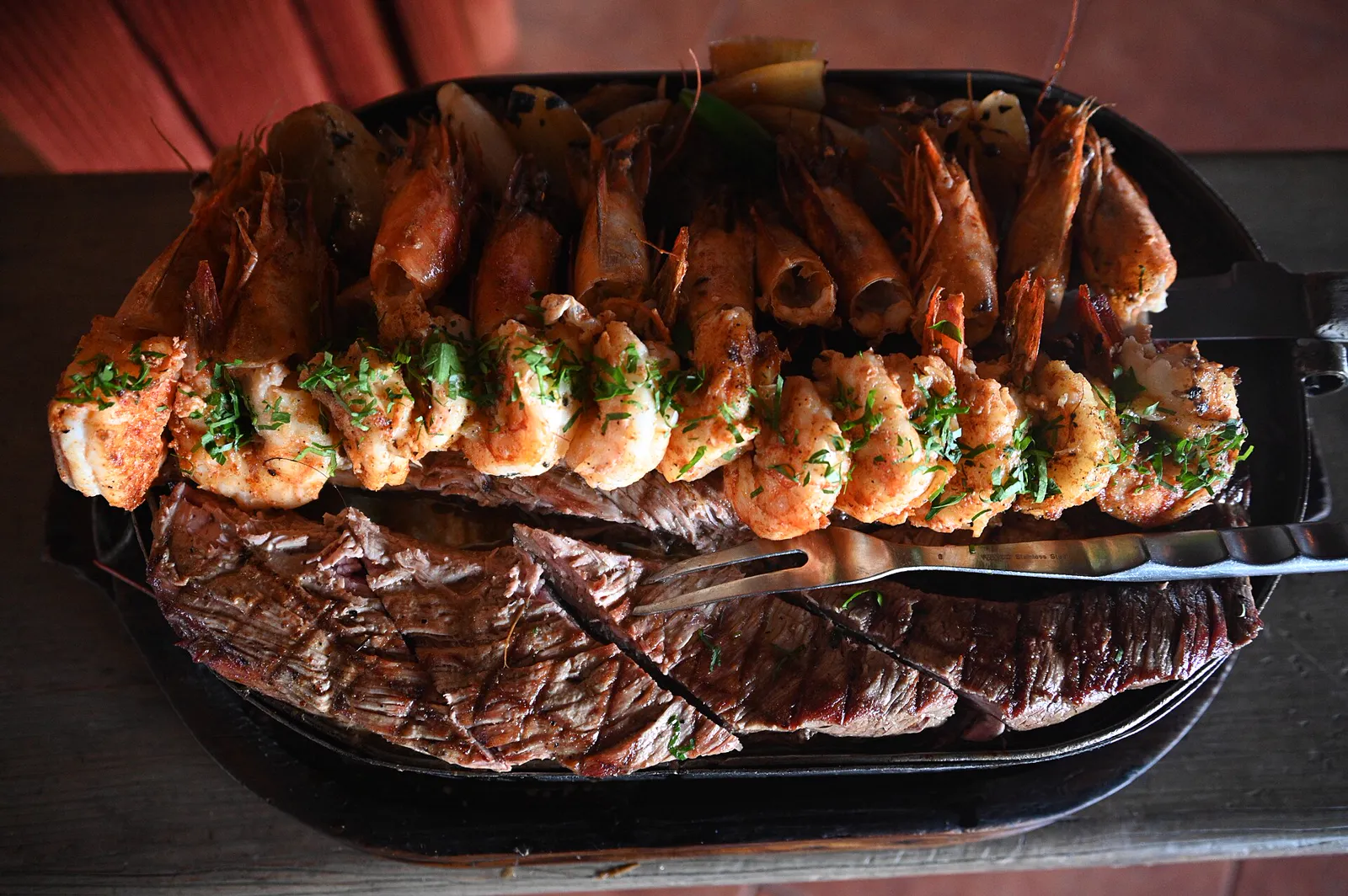 Shrimp and grilled steak on a hot platter